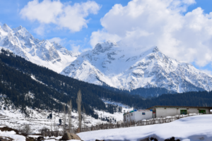 Majestic snow-capped mountains under a bright blue sky in winter.